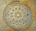 6 circles, 12 circles, 18 stars - number patterns on a drain cover.